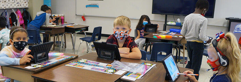 kids working on ipads in class