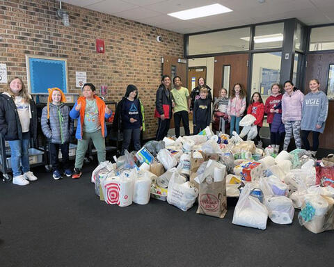Students pose proudly with the donations that collected for NAWS Humane Society